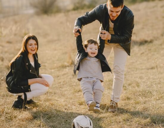 Photo of Family Having Fun With Soccer Ball
