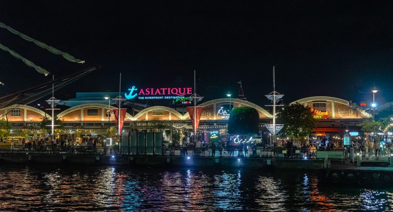 a night view of a restaurant on the water