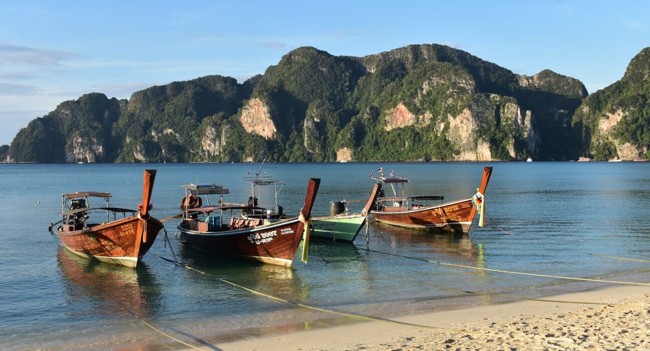 a couple of boats that are sitting in the sand