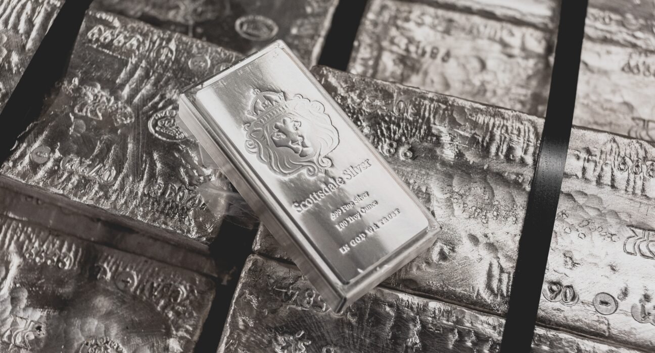 a scottsdale mint stacker bar sits on top of a pallet of raw silver.