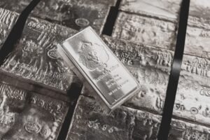 a scottsdale mint stacker bar sits on top of a pallet of raw silver.