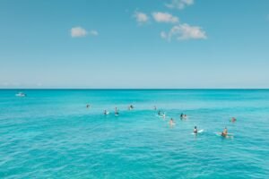 People Surfing on Sea