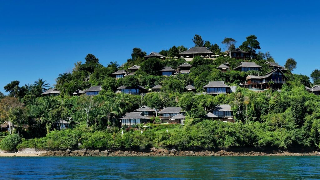 white and brown house near body of water during daytime