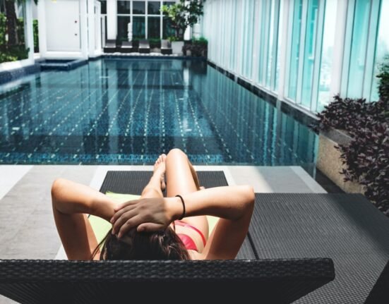 woman laying on brown chaise lounge