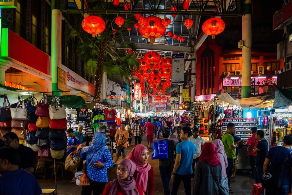 people walking on street during nighttime Kuala Lumpur