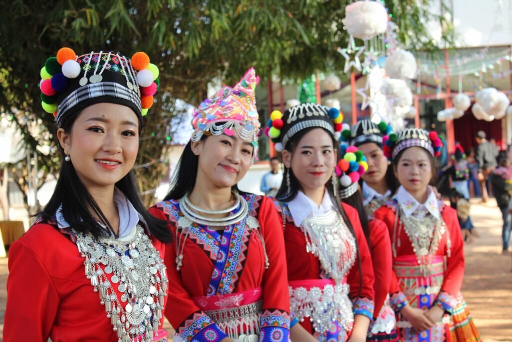 woman in red and white floral dress smiling Laos