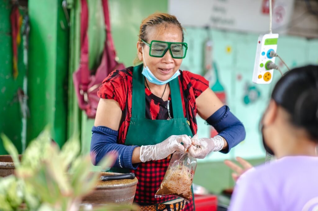 man in red and black vest wearing green goggles