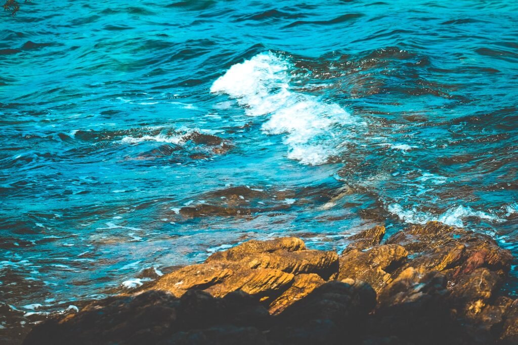 brown rocky shore with ocean waves during daytime