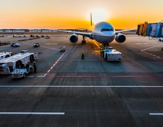 gray airplane on parking