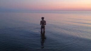 woman standing on body of water