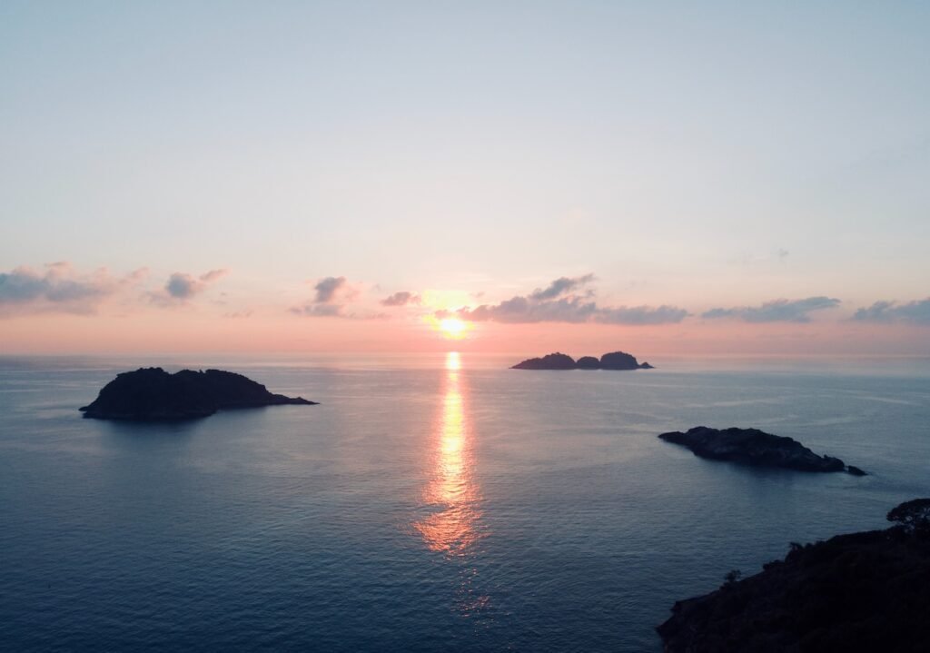 the sun is setting over a body of water