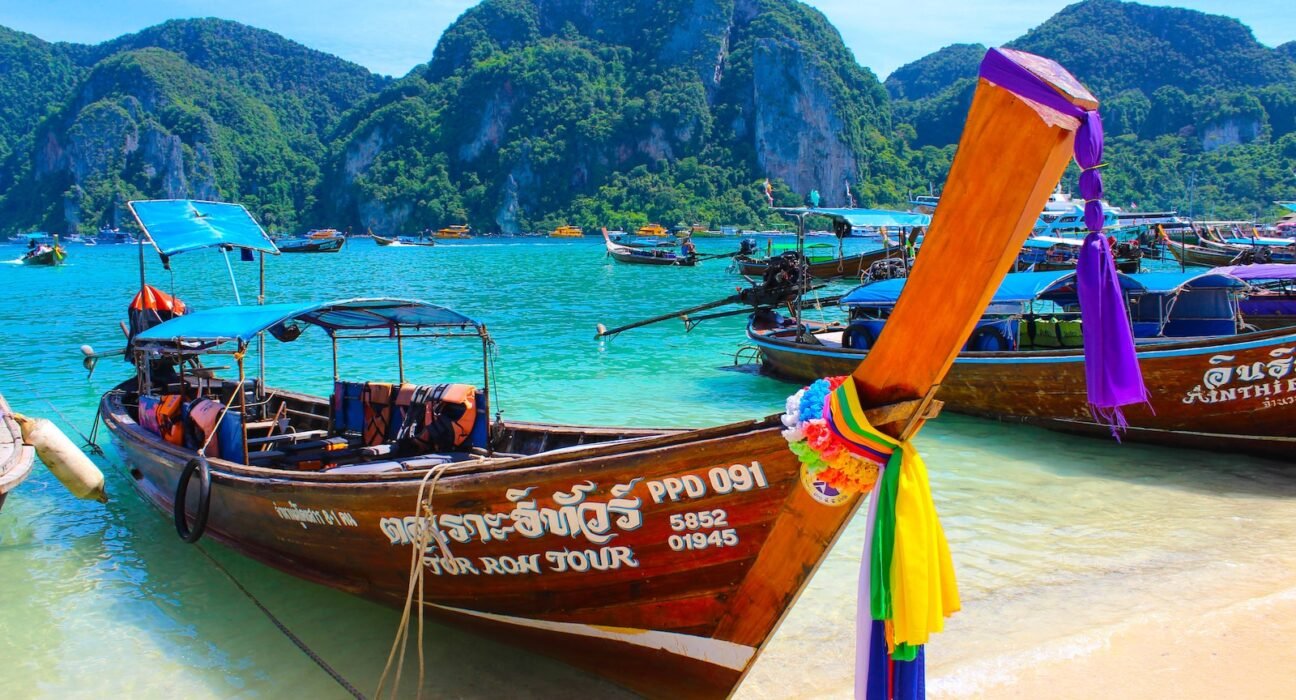 brown wooden boat on beach shore during daytime