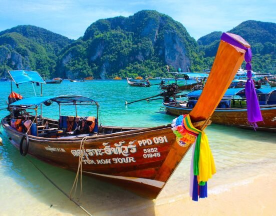 brown wooden boat on beach shore during daytime