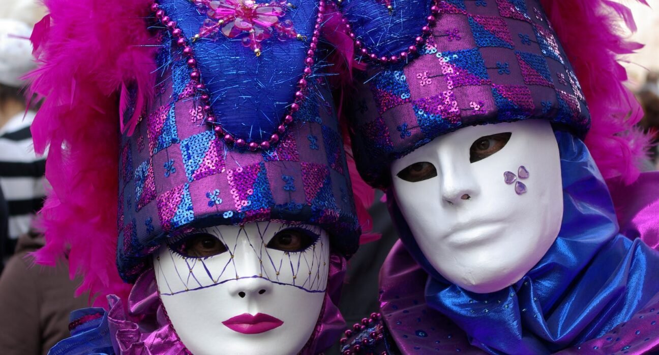 Two people wearing purple and blue masks
