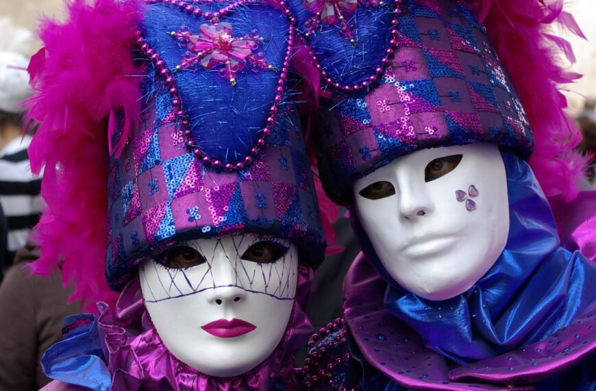 Two people wearing purple and blue masks