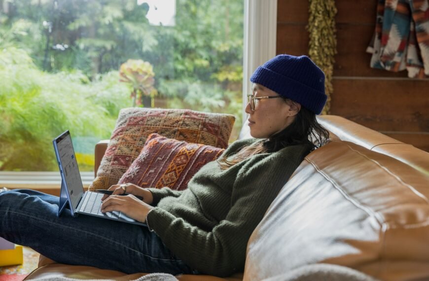 a person sitting at a table using a laptop