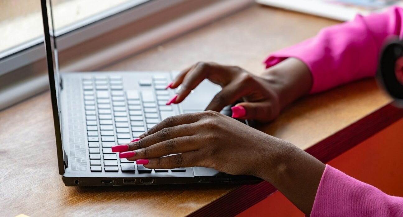 a woman using a laptop computer on a table