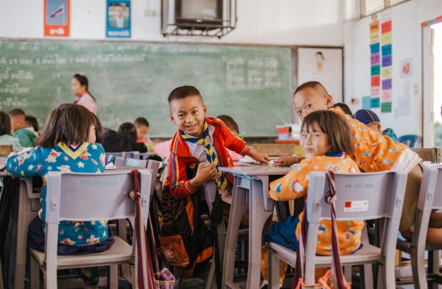 a group of children sitting at desks in a classroom