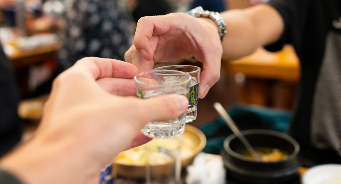 person holding clear drinking glass with water