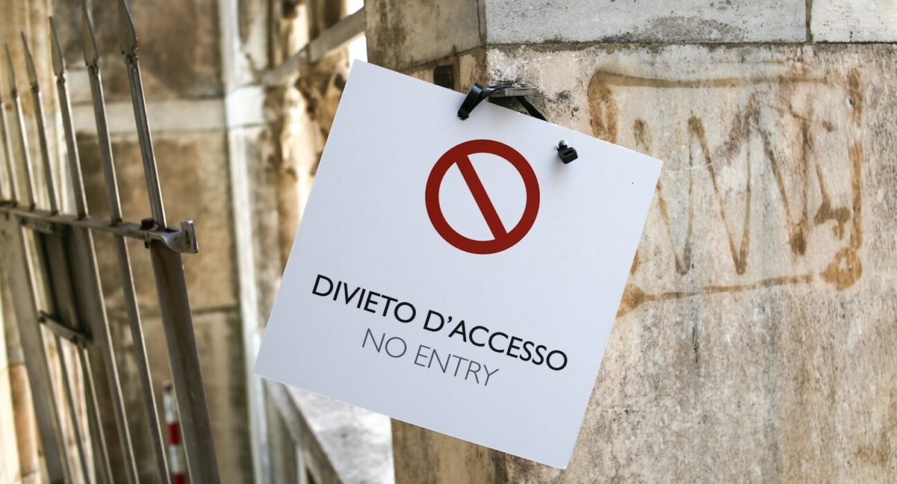 a no entry sign hanging on the side of a building