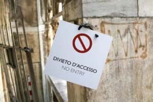 a no entry sign hanging on the side of a building