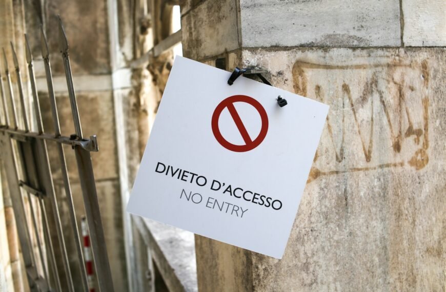 a no entry sign hanging on the side of a building