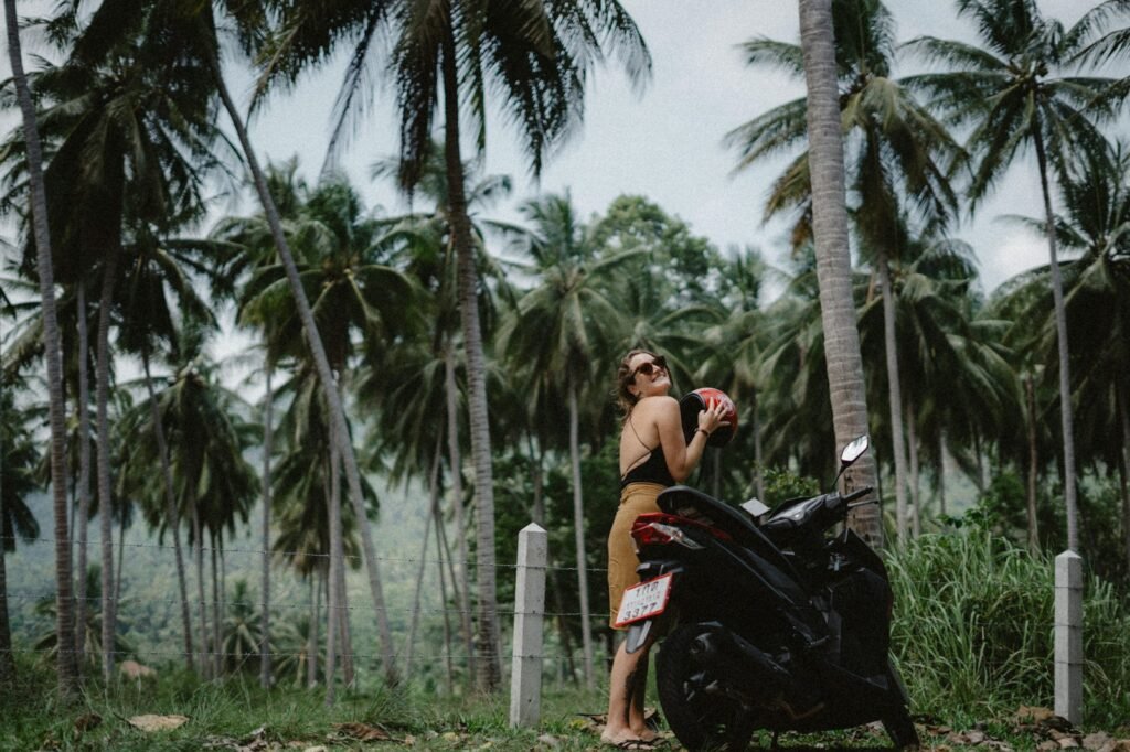 a man standing next to a parked motorcycle