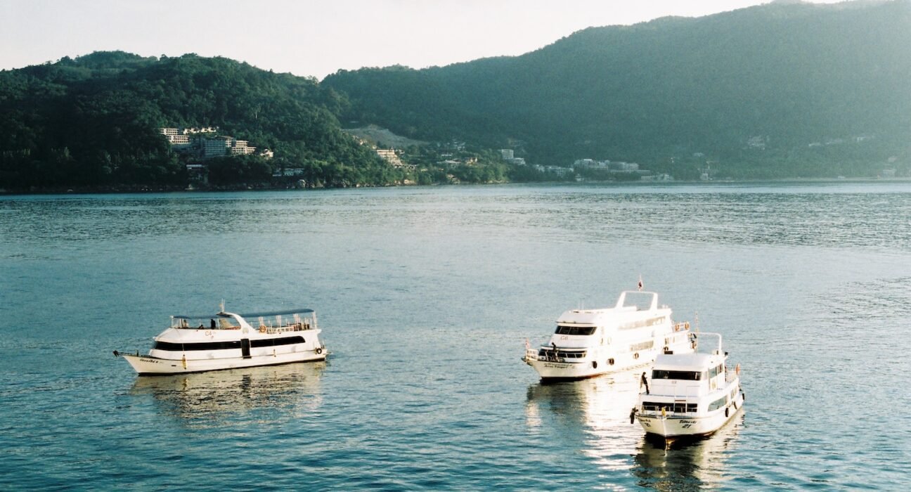 white and black boat on body of water during daytime
