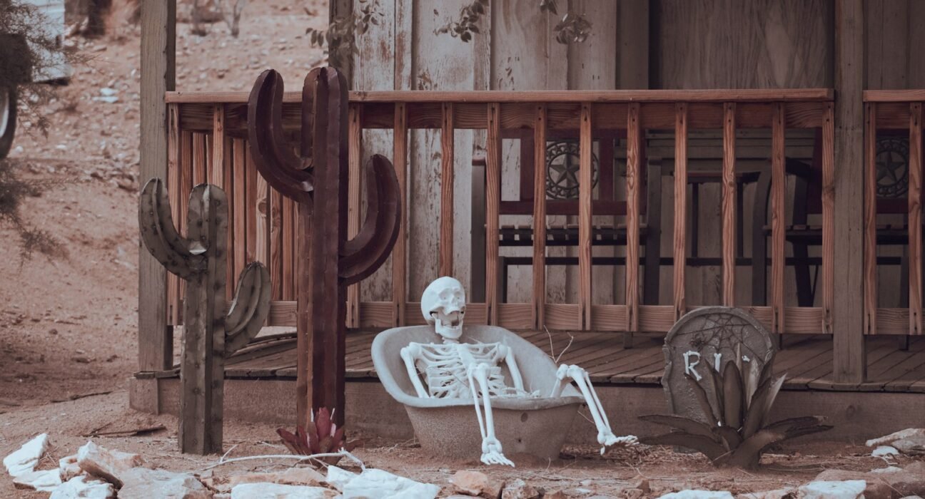 man sitting on brown wooden bench