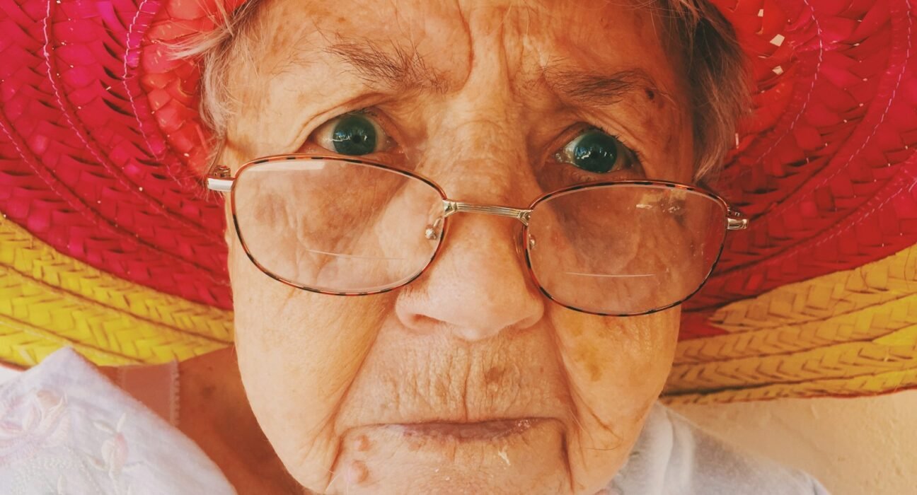 woman in white top wearing eyeglasses