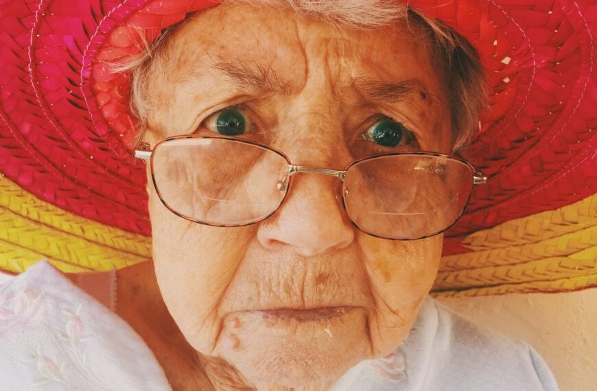 woman in white top wearing eyeglasses