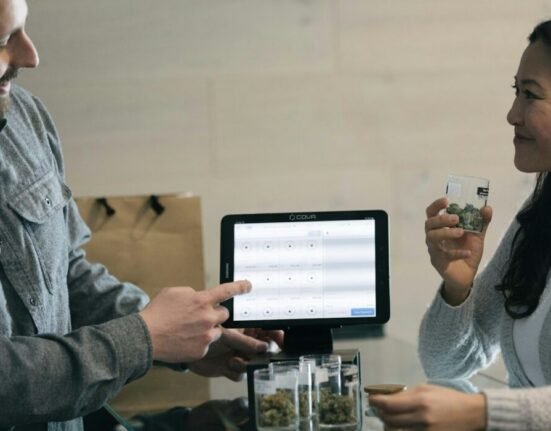 a man and a woman holding up a tablet