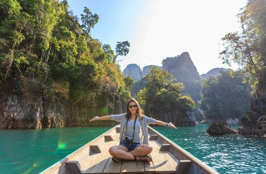 Photo of Woman Sitting on Boat Spreading Her Arms