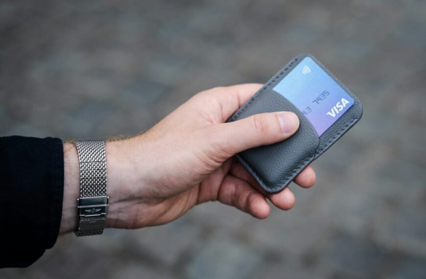 a person holding a credit card in their hand