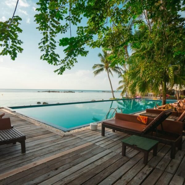 brown wooden table and chairs on brown wooden deck near body of water during daytime