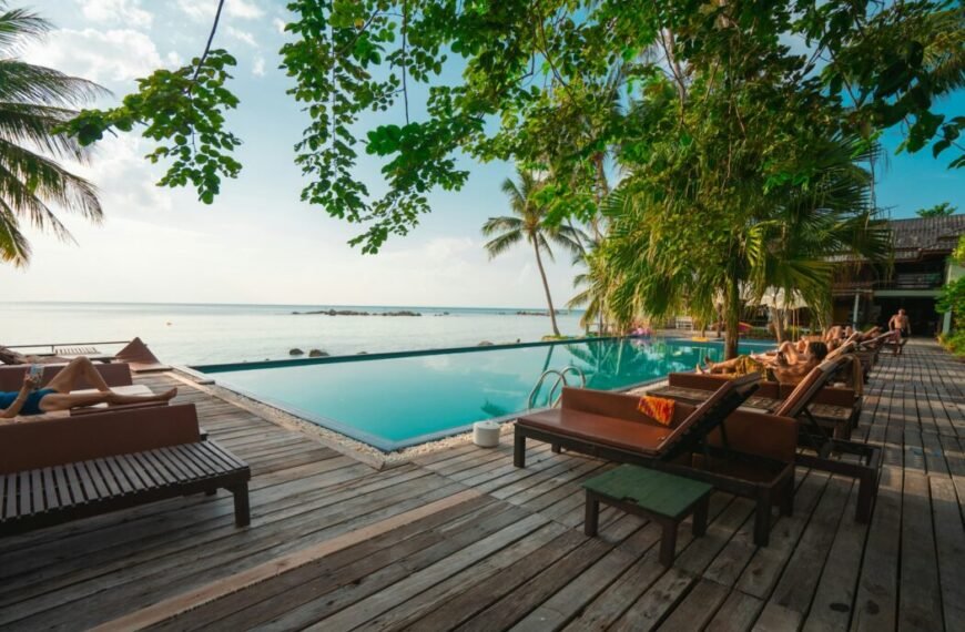 brown wooden table and chairs on brown wooden deck near body of water during daytime