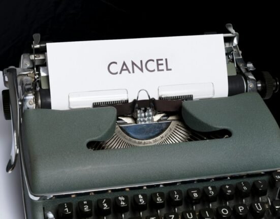 green and white typewriter on black textile