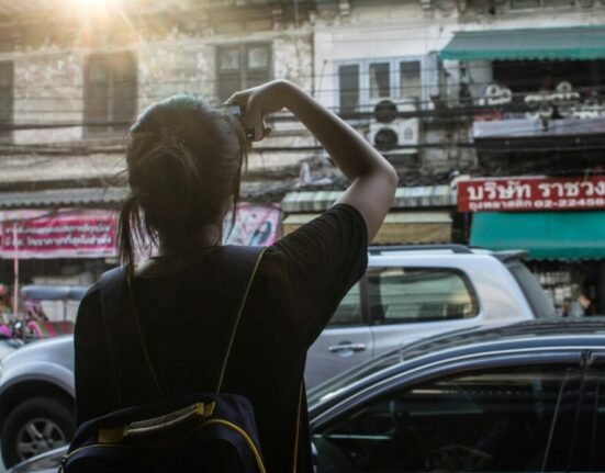 person looking at white building