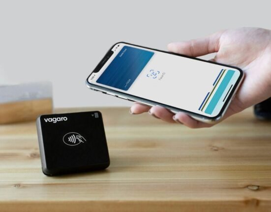 a person holding a cell phone next to a charger