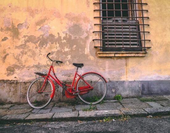 red bike leaned on wall