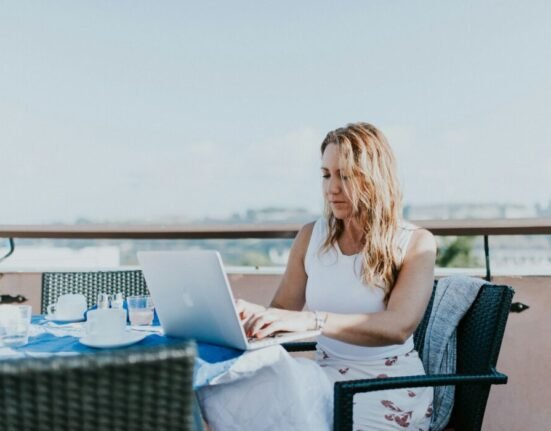 woman sitting on chair while using MacBook