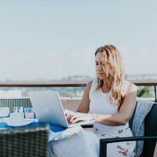 woman sitting on chair while using MacBook