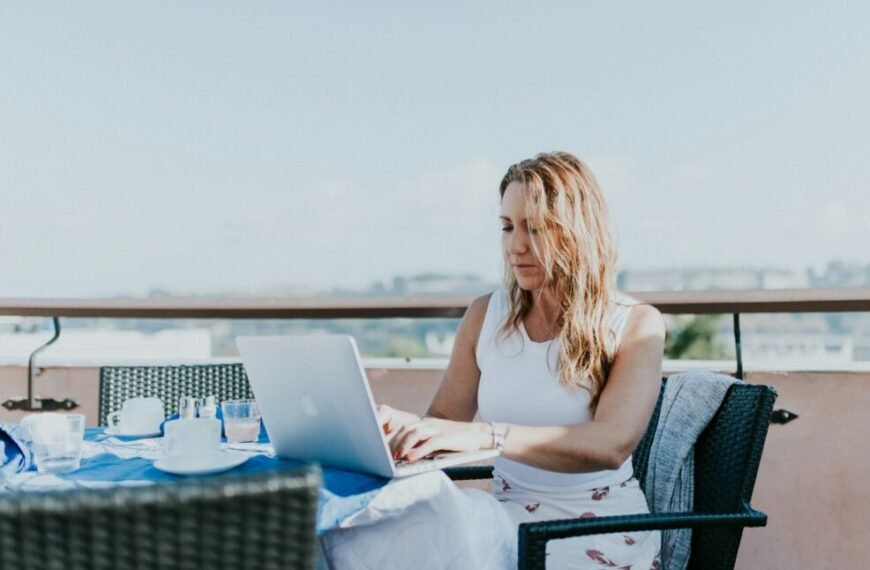 woman sitting on chair while using MacBook