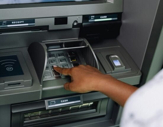 a person using an atm machine to pay money