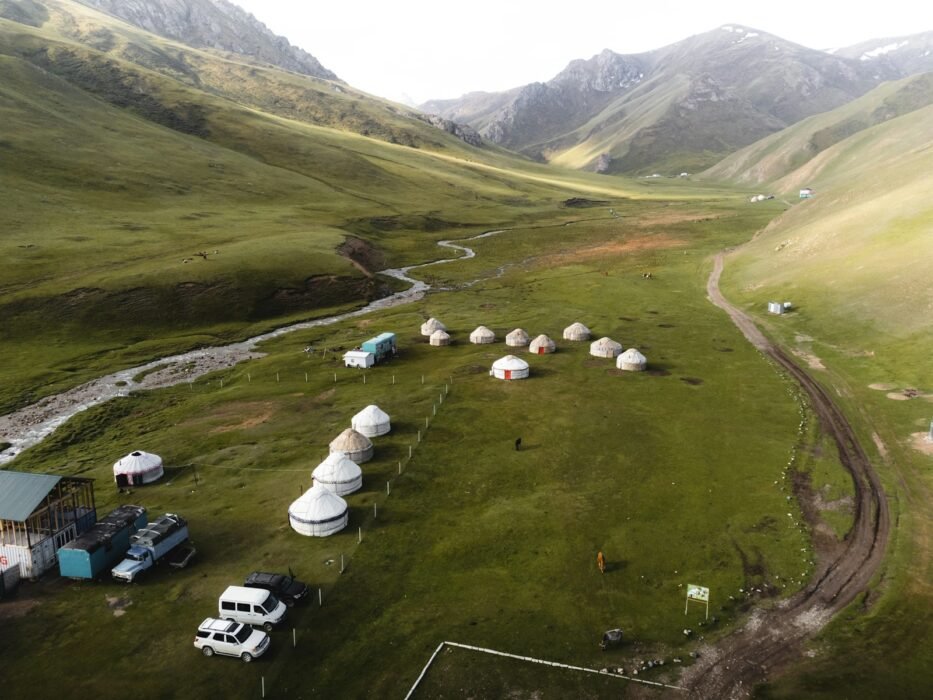 An aerial view of a farm with a stream running through it