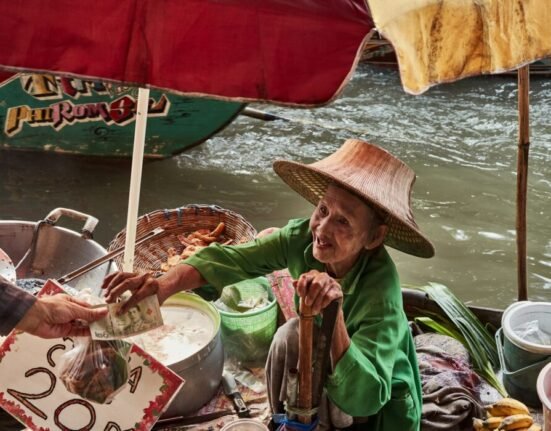 a woman in a straw hat is serving food to another woman