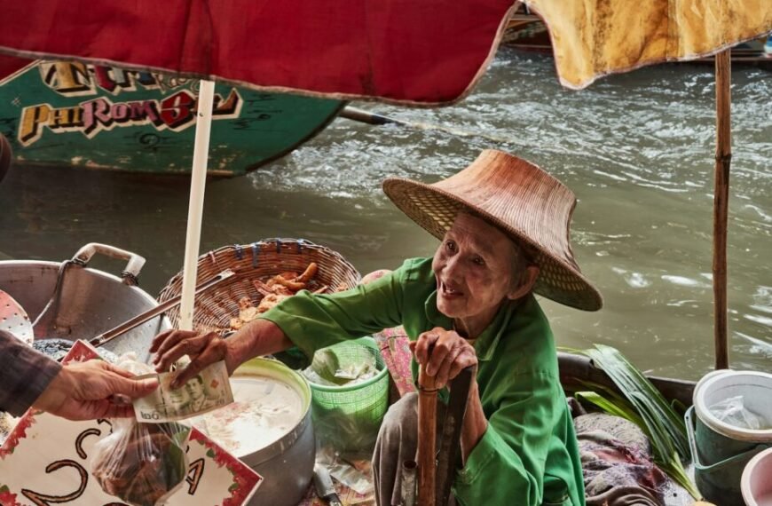 a woman in a straw hat is serving food to another woman