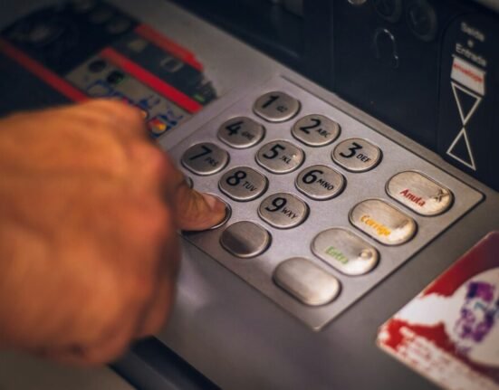 person holding white and red card