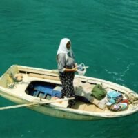 woman standing on middle of boat