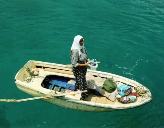 woman standing on middle of boat